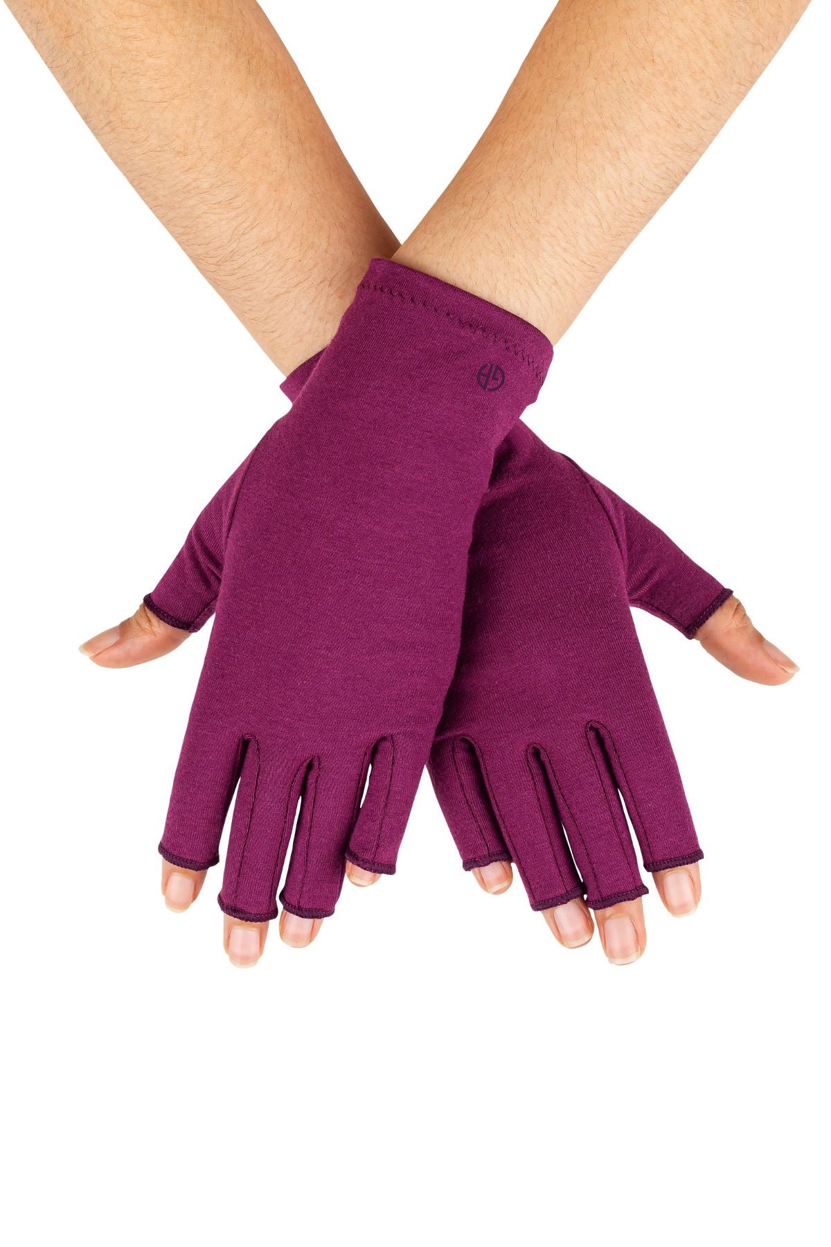 A pair of Plum Purple Compression Gloves worn by a woman with arthritis, her hands crossed at wrists with palms facing down on a white background.