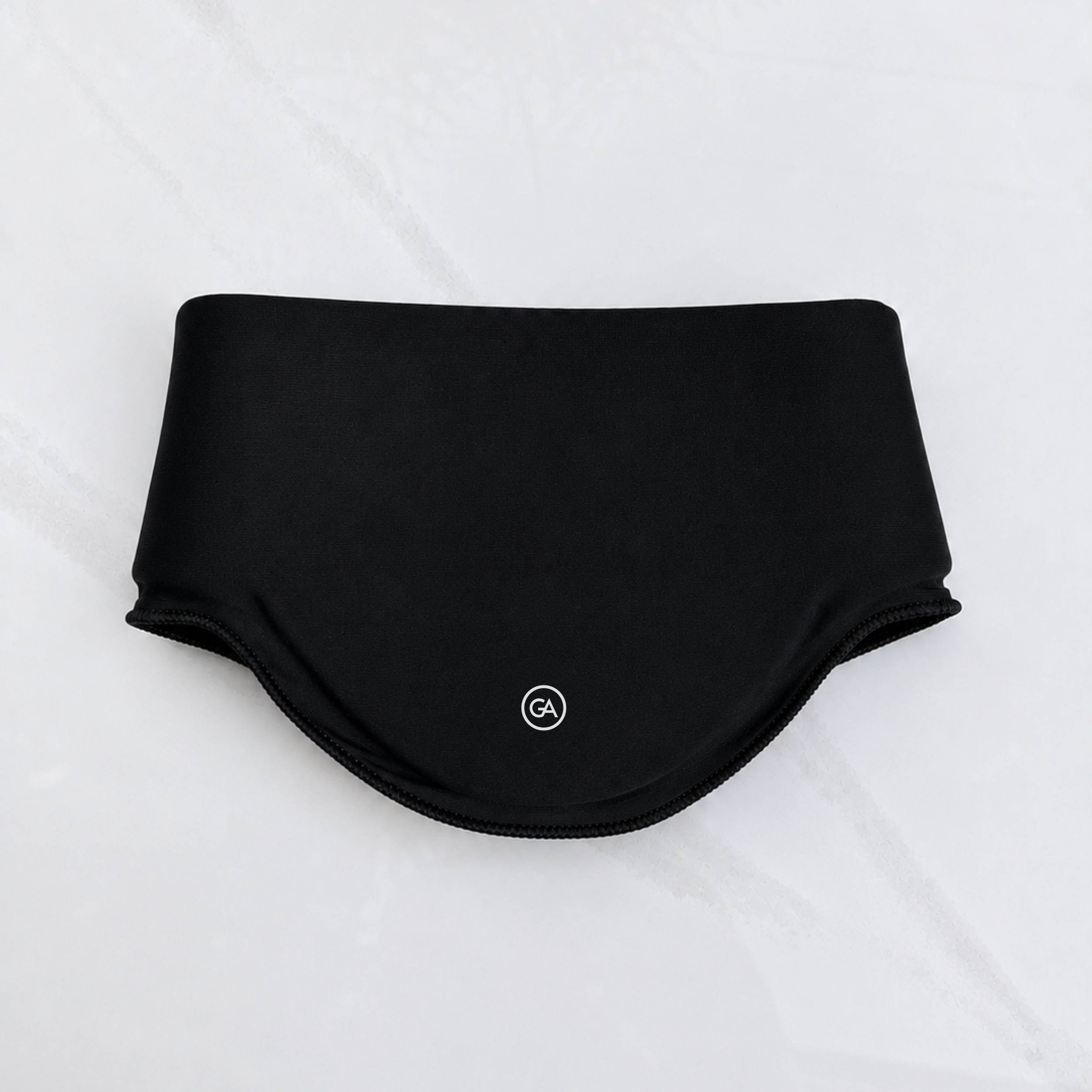 A jet black cooling neck wrap laid flat on a light gray marble-textured background.
