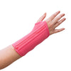 A woman with arthritis is showing her hand in close-up, wearing a Bubblegum Pink Wrist Brace with a zipper; the background is white.