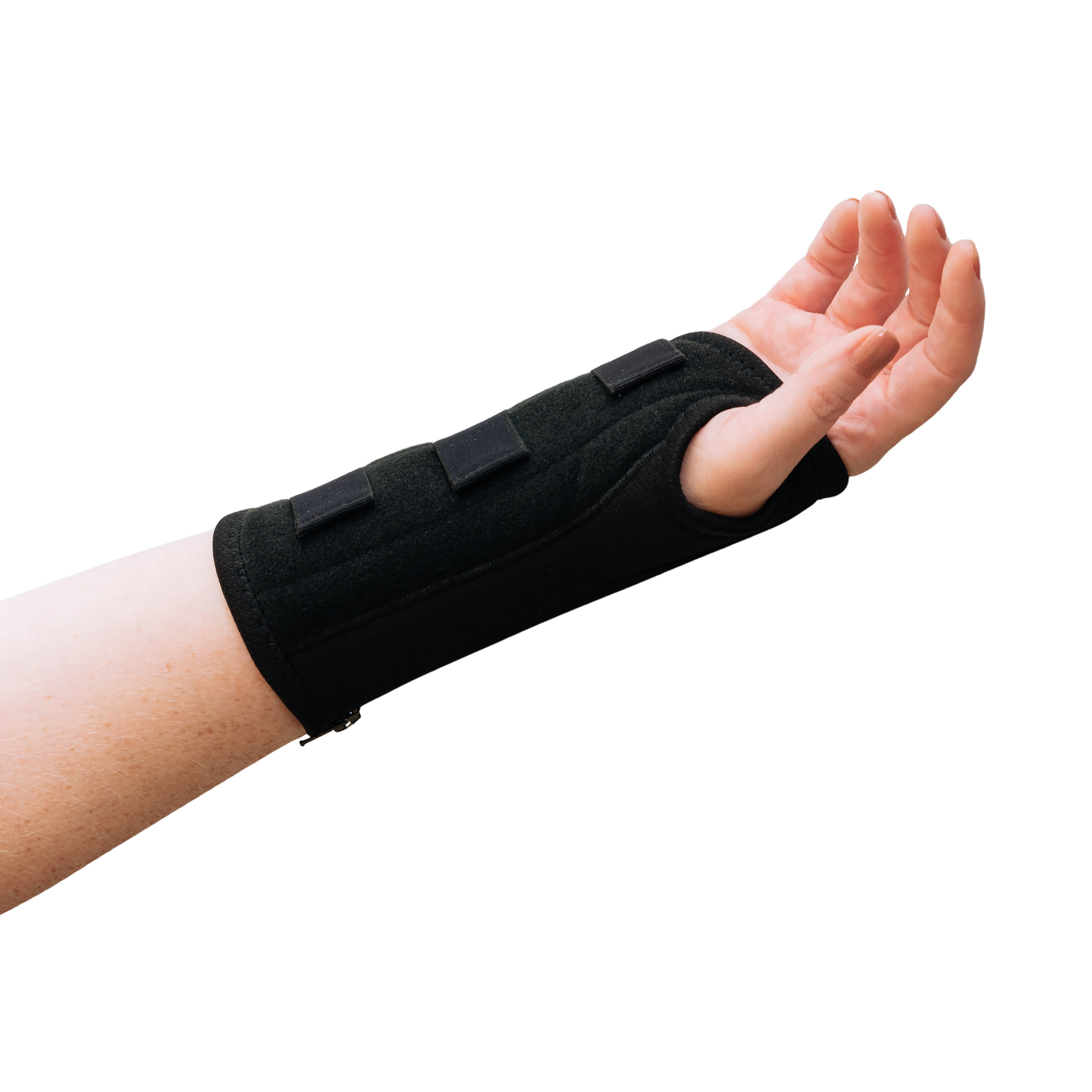 A woman with arthritis is showing her hand in close-up, wearing a Classic Black Wrist Brace with straps. The background is white.
