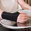 Woman with arthritis wears a wrist brace for carpal tunnel syndrome and joint pain the black brace has a zipper