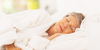 A woman with arthritis sleeping in bed. 