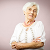 a woman in her 70s with white hair and arthritis on a beige background