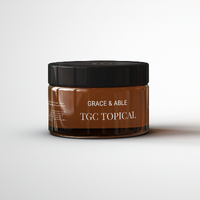 A brown jar with a black lid sits on a white background. The jar is labeled 'Grace & Able TGC Topical.' Inside the jar there is a salve that is a natural option for soothing swelling and soreness, making it a great choice for people with arthritis.