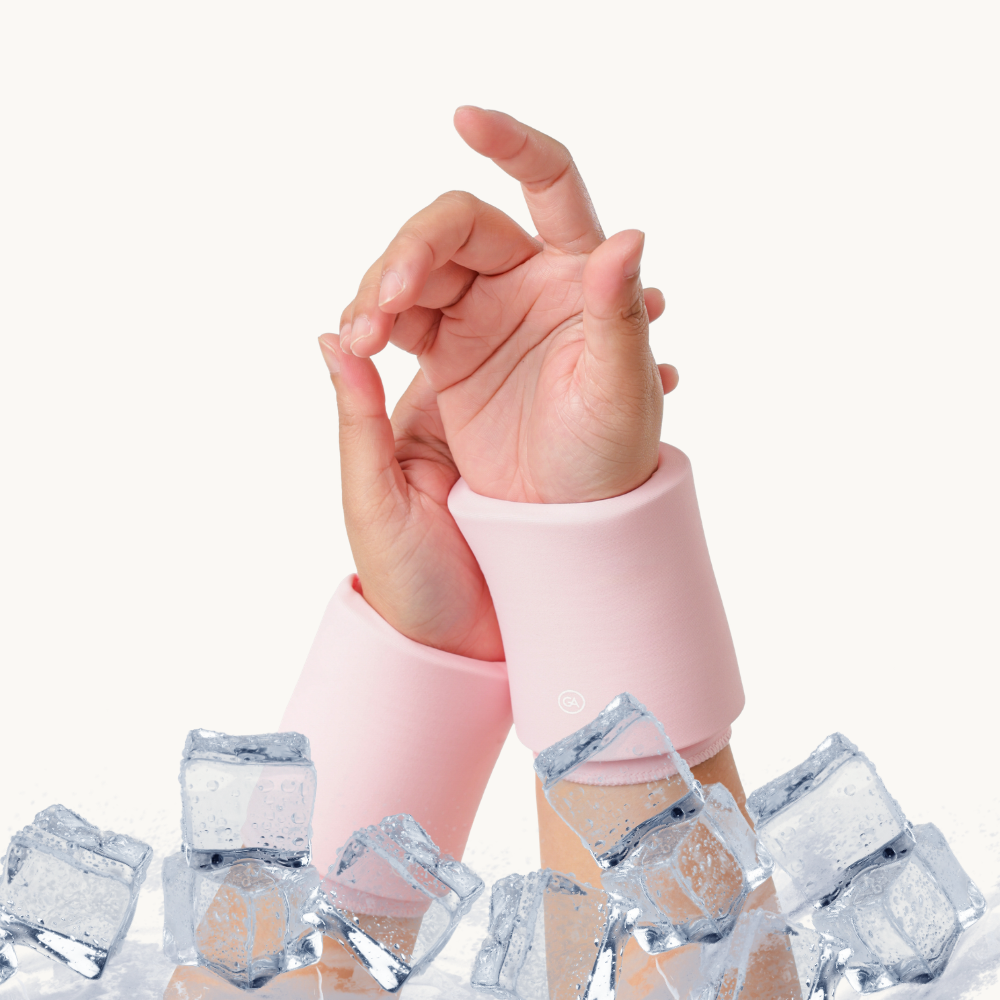 A pair of pastel pink cooling compression sleeves for wrist with ice cubes scattered around the wrists against a clean white background.