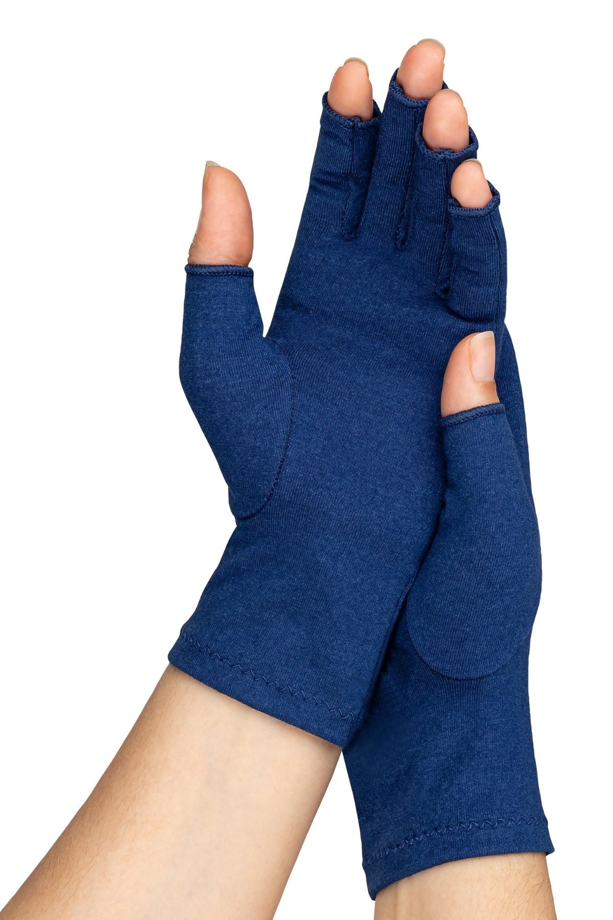 A woman with arthritis wearing Marine Blue Compression Gloves. Her hands are crossed with palms to the front.