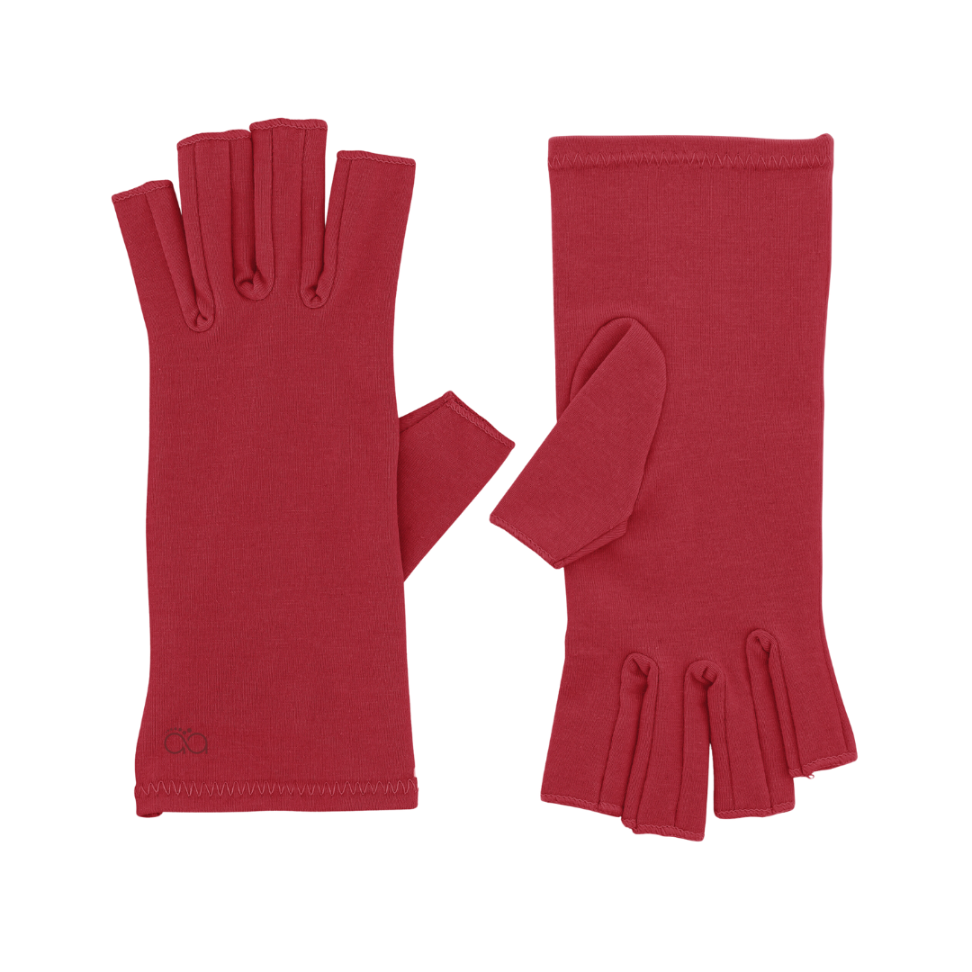 A pair of Chili Red Compression Gloves, perfect for women with arthritis, is lying on a white background; (one glove is displaying the inner side, the other the outer)