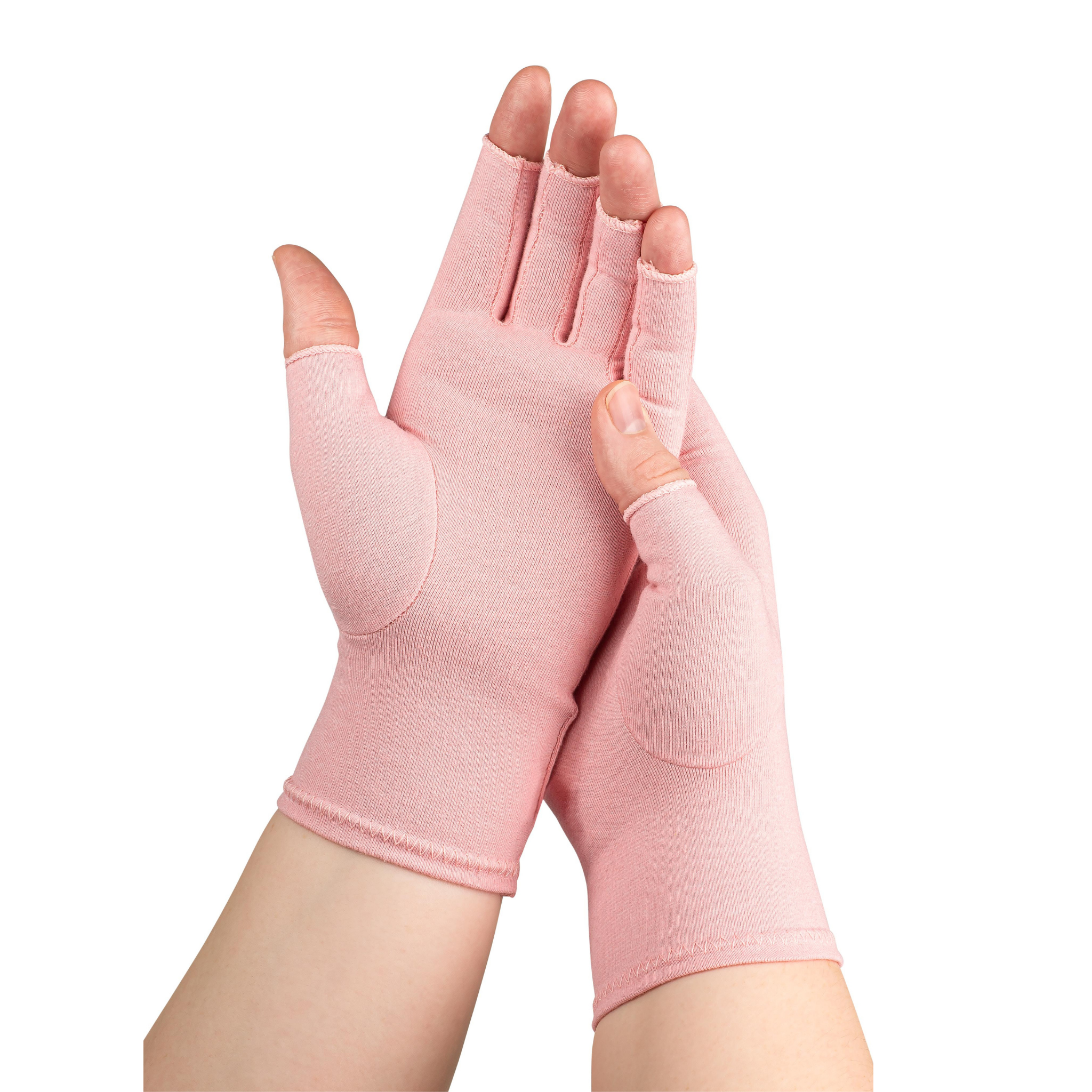 A woman with arthritis wearing Ballet Pink Compression Gloves. Her hands are crossed with palms to the front.