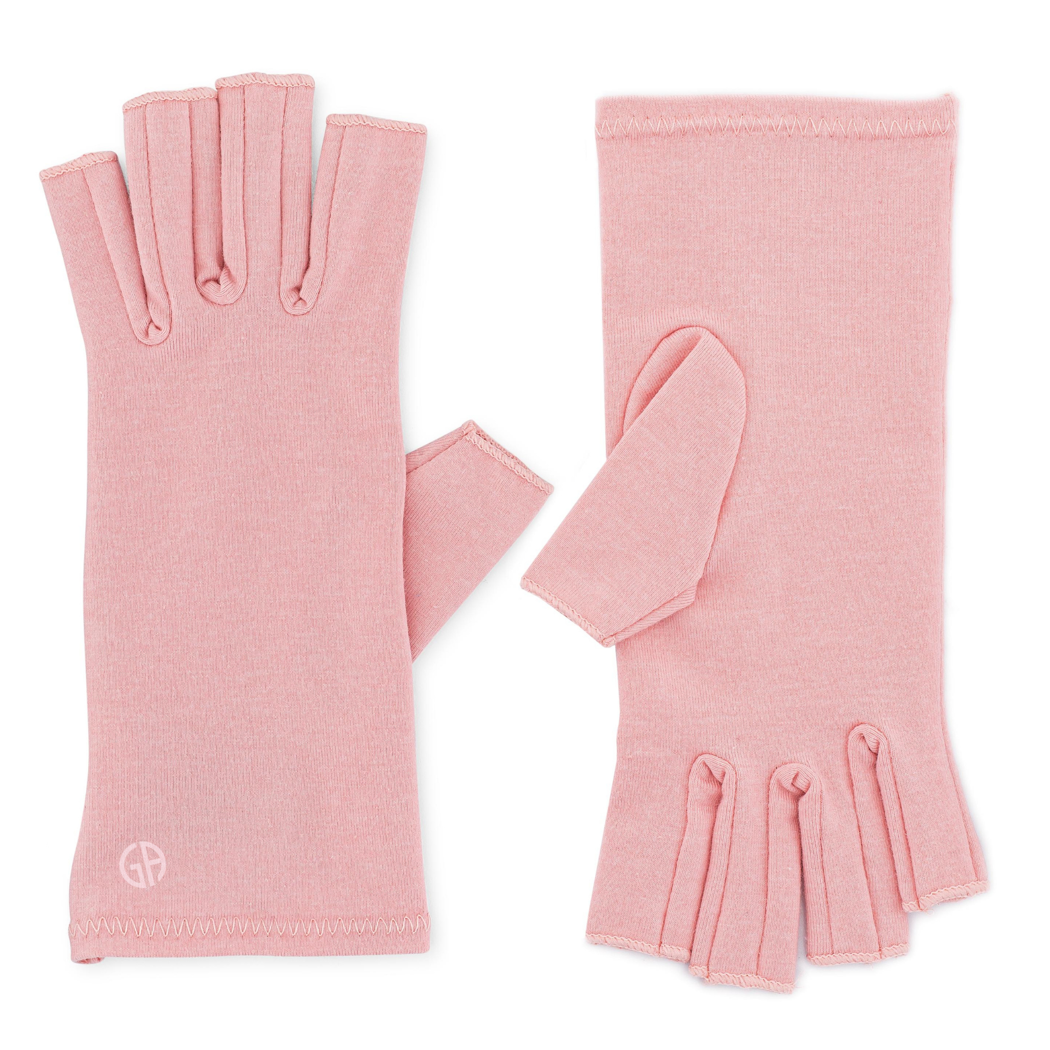 A pair of Ballet Pink Compression Gloves, perfect for women with arthritis, laid flat on a white background; (one glove is displaying the inner side, the other the outer)