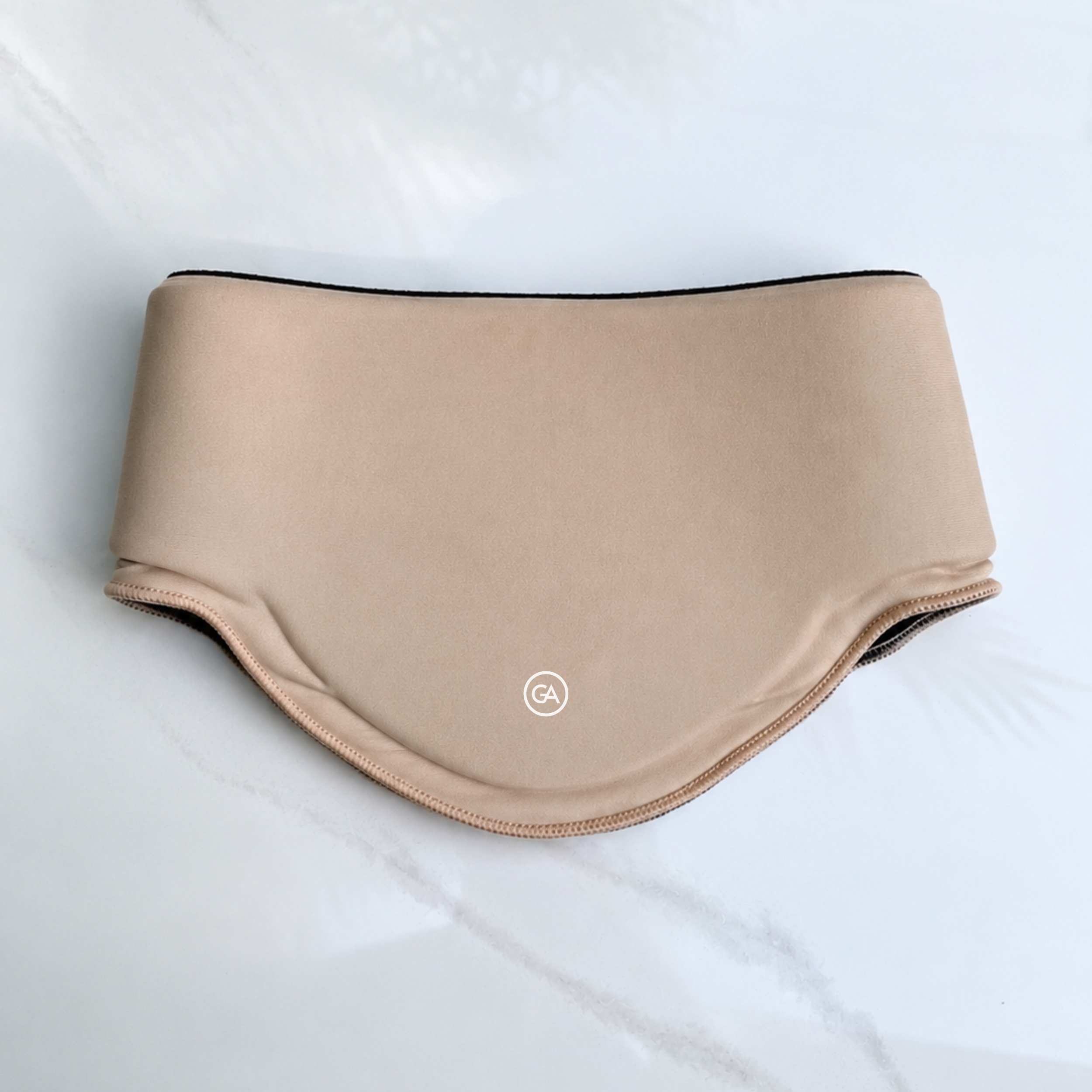 A latte beige cooling neck wrap, laid flat on a light marble-like surface.