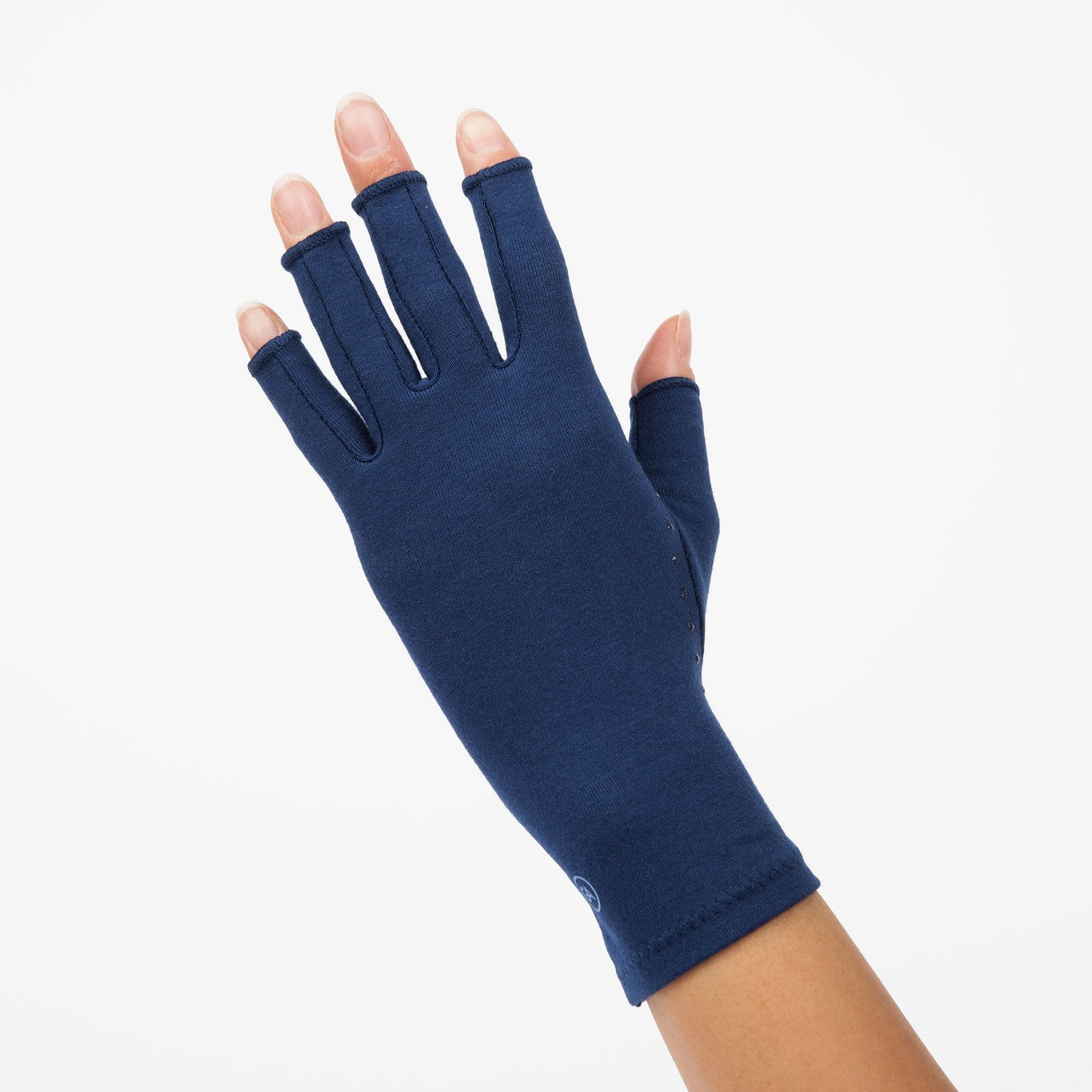 marine blue compression gloves with silicone dots on palm worn by a hand with arthritis back of hand on a white background