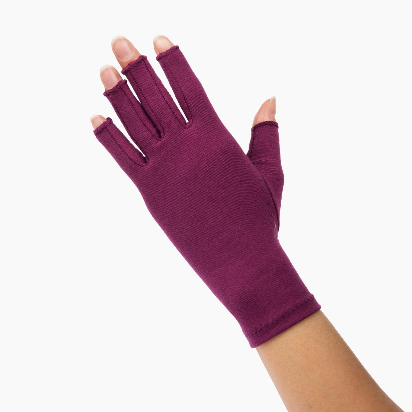 plum purple compression gloves with silicone dots on palm worn by a hand with arthritis back of hand waving on a white background