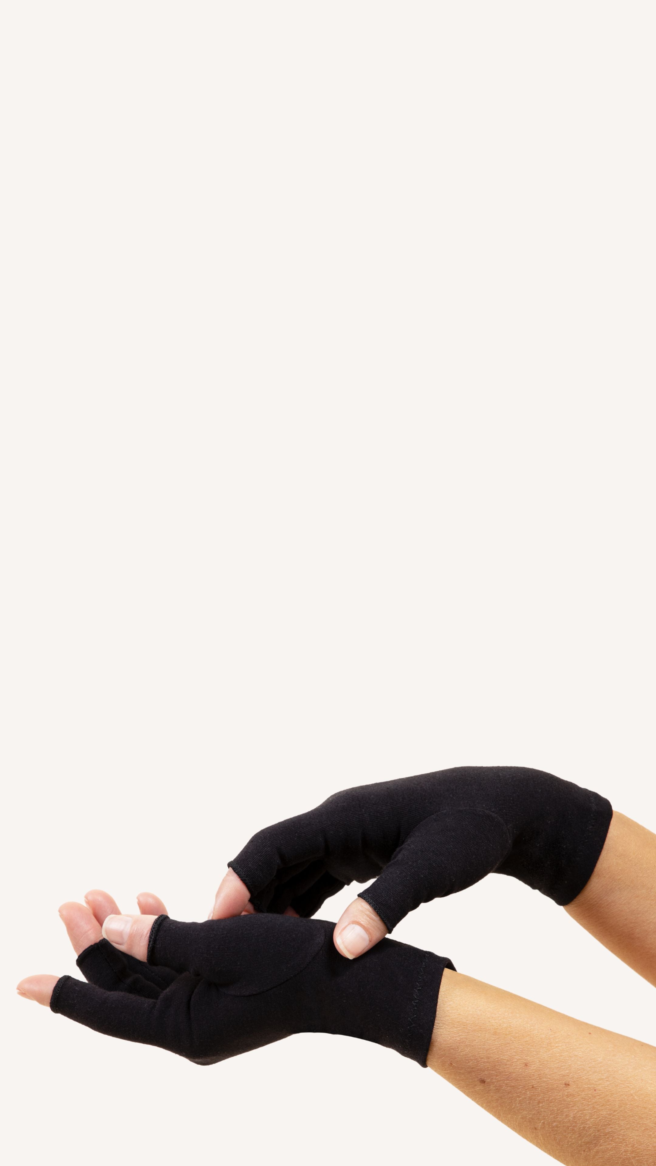 woman with arthritis wearing black Grace & Able compression gloves