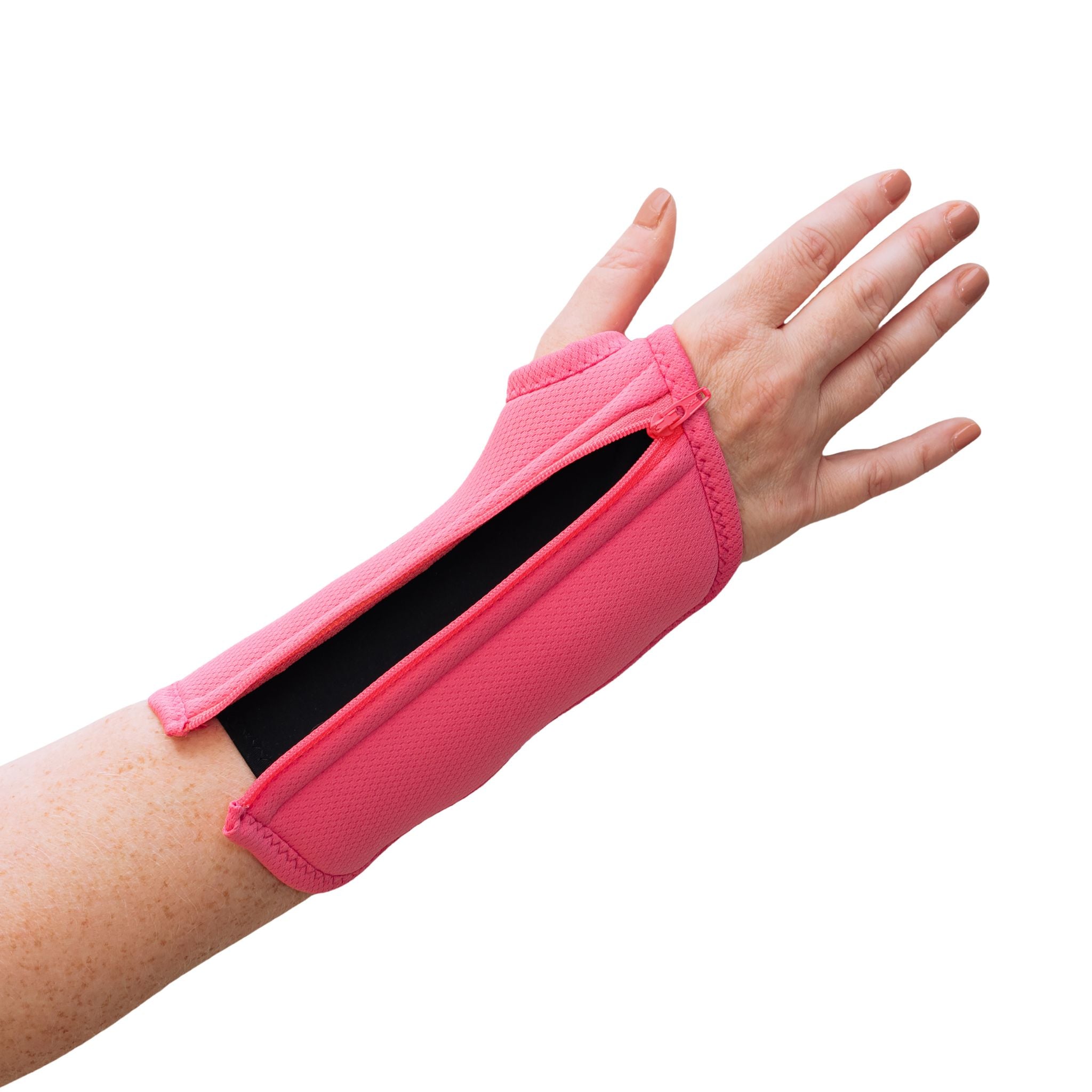A woman with arthritis is showing her hand in a fully unzipped Bubblegum Pink Wrist Brace with zipper. Soft Moisture-wicking liner fabric can be seen from underneath. The background is white.