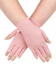A close up of hands of a woman with arthritis, wearing Ballet Pink Compression Gloves and showing the backs of her hands crossed at the wrist